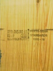 Solid sawn scaffold plank that has of mill/grade stamp and OSHA-compliant stamp