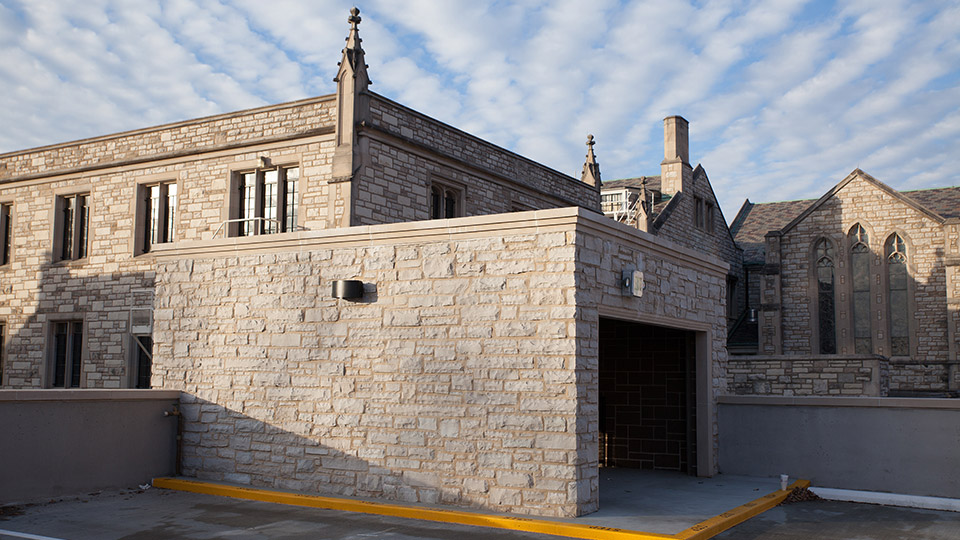 Limestone veneer on the exterior of the parking garage stairwell ties the structure to the limestone church.