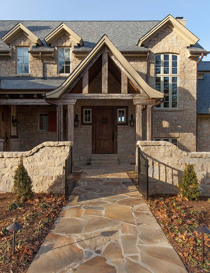 Shawnee Flagstone leads through the garden wall to the home’s front door. This project used 35 tons of this Shawnee Flagstone on this house and grounds.
