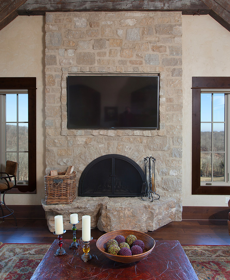 One of three fireplaces featuring hearthstones of unfinished limestone.