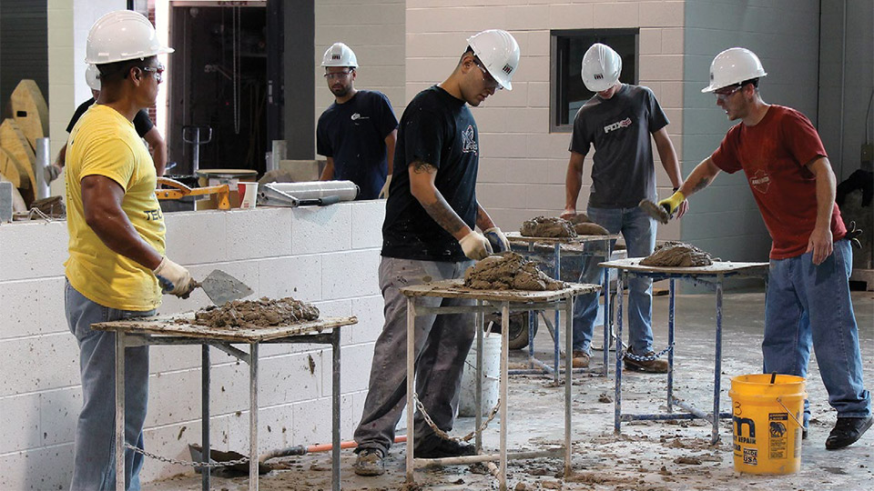 Pre-job brick students spread mortar at the BAC/IMI International Training Center in Bowie, Md.