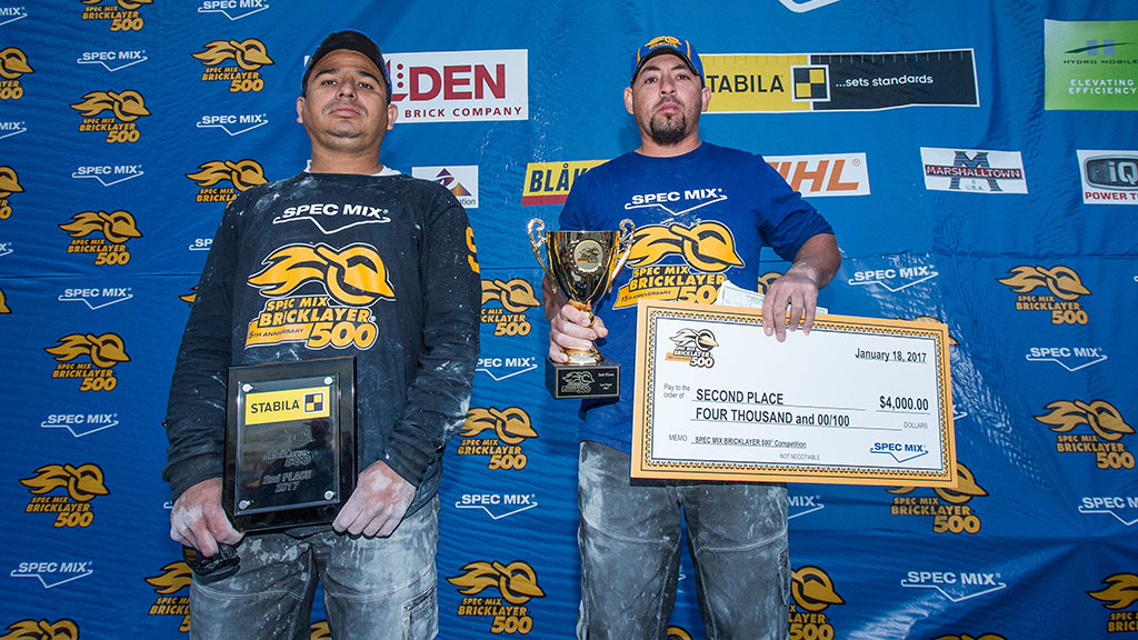 SPEC MIX TOP CRAFTSMAN winner Brian Tuttle (left) and his mason tender Todd Eldredge (right) stand by their winning wall.