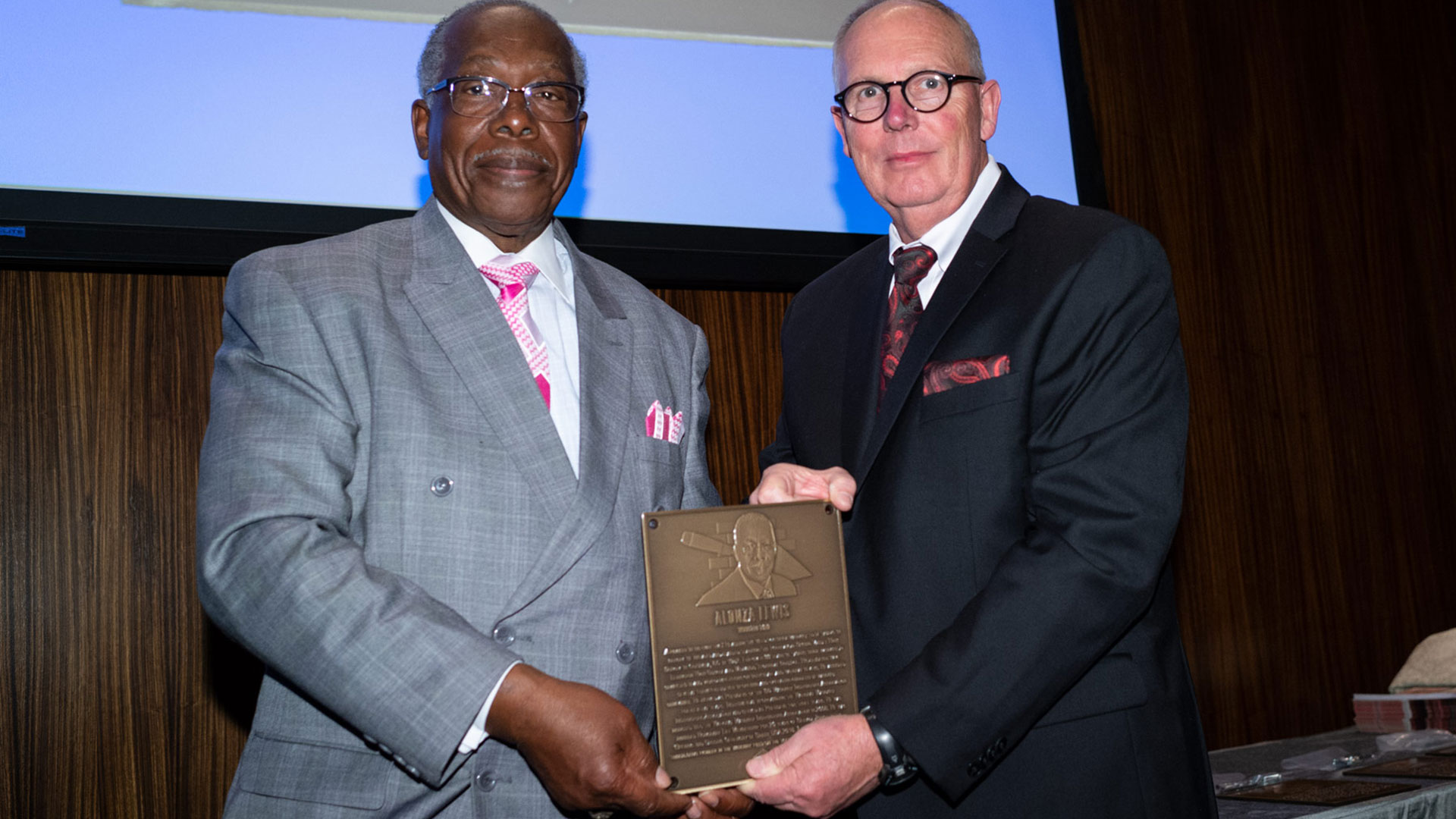 MCAA Chairman Paul Odom (right) presents Alonza Lewis with his Masonry Hall of Fame plaque.