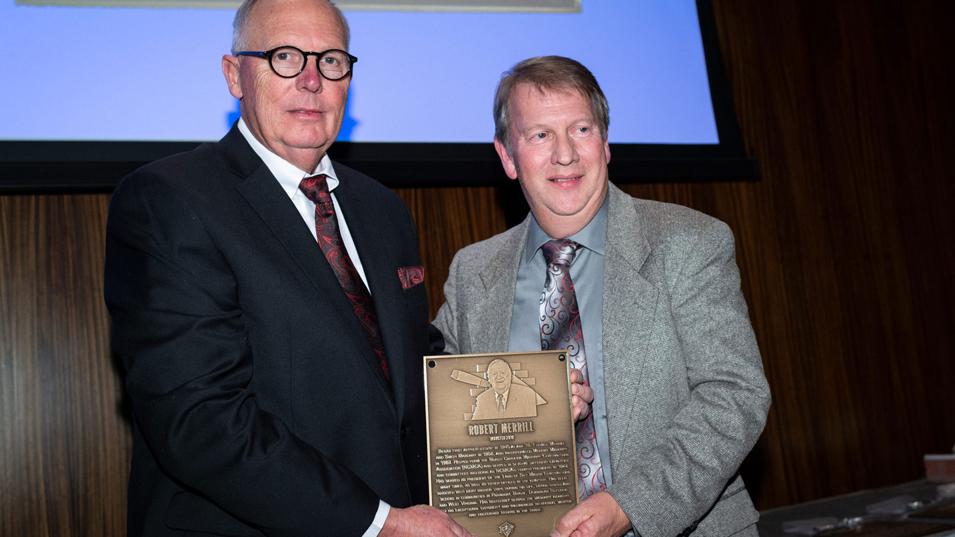 MCAA Chairman Paul Odom (right) presents Steve Stout with Robert Merrill’s Masonry Hall of Fame plaque.