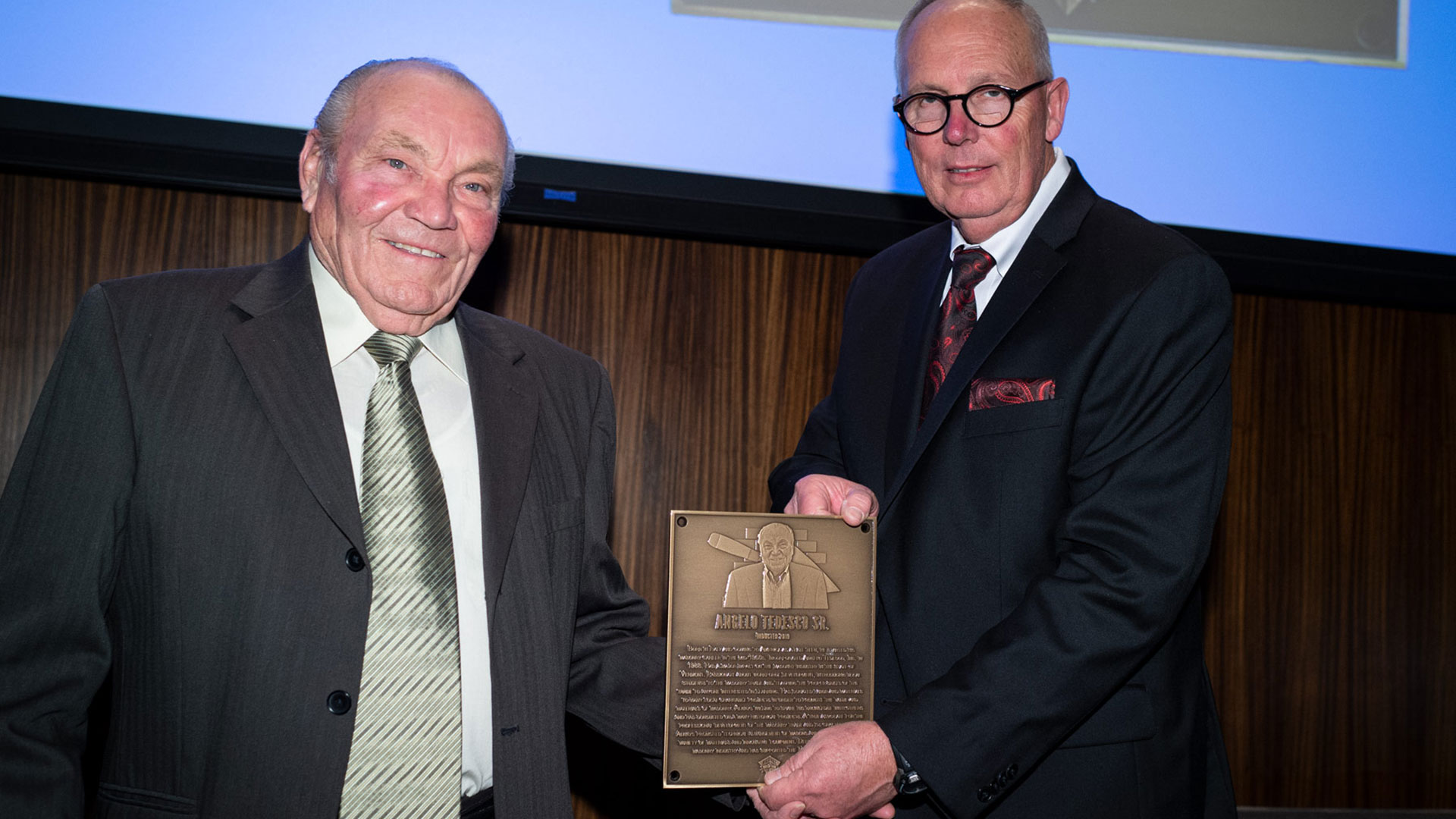MCAA Chairman Paul Odom (right) presents Angelo Tedesco, Sr. with his Masonry Hall of Fame plaque.