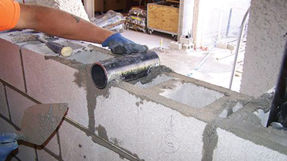 For this project, the bricklayers worked alongside the mechanical, electrical, and plumbing (MEP) trades to install pipe sleeves through the masonry walls as they were constructed, per the BIM model.