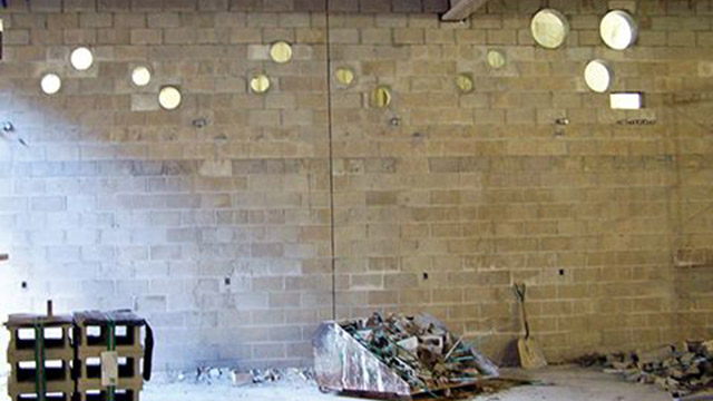 As the concrete masonry wall was constructed, the bricklayers installed 468 sleeves for fire protection, 231 sleeves for plumbing, 343 sleeves for water, and 10 miscellaneous sleeves. There was a total of 1537 sleeves.