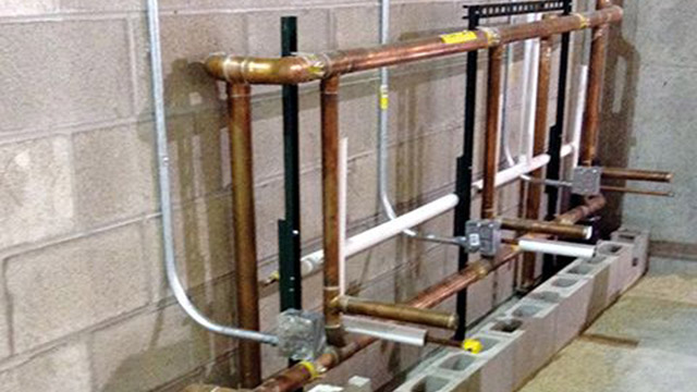 The BIM model made it possible to prefabricate the toilet room plumbing assemblies on steel strut racks to conserve space onsite. The plumbing racks were integrated into the block walls per the coordination model.